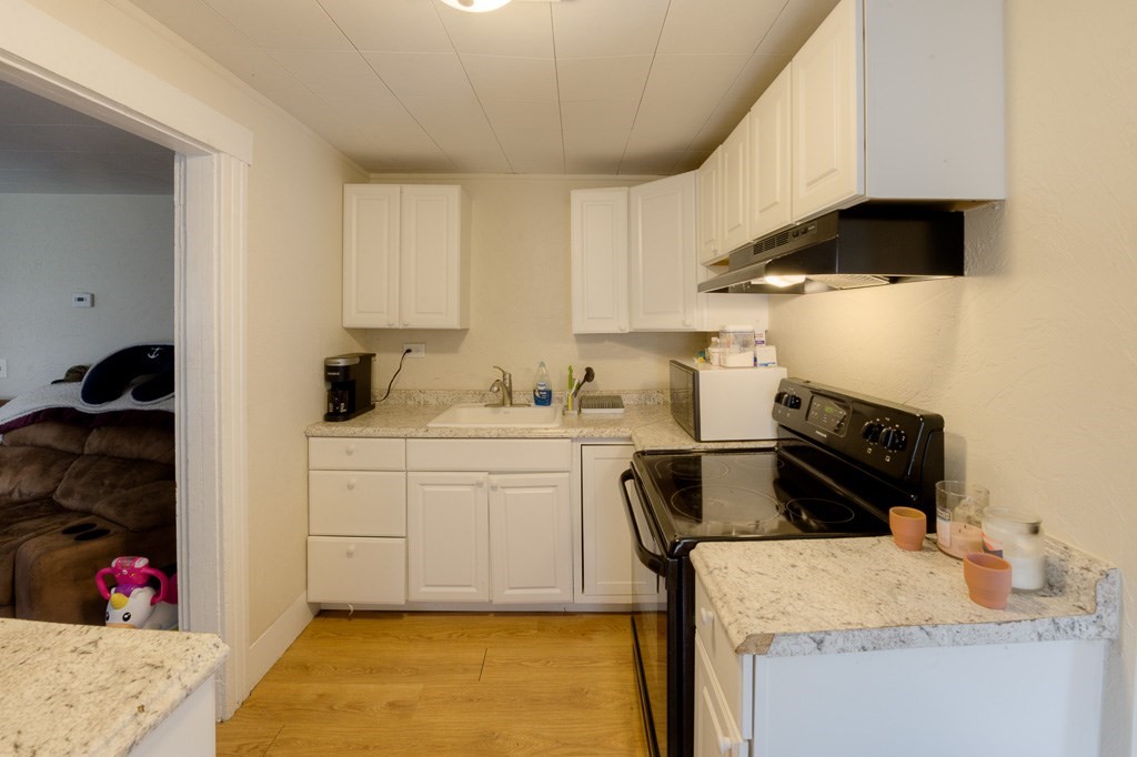 92 Mill Street Lancaster, MA 01523 - Photo 29 of 42 a kitchen with a sink appliances and cabinets