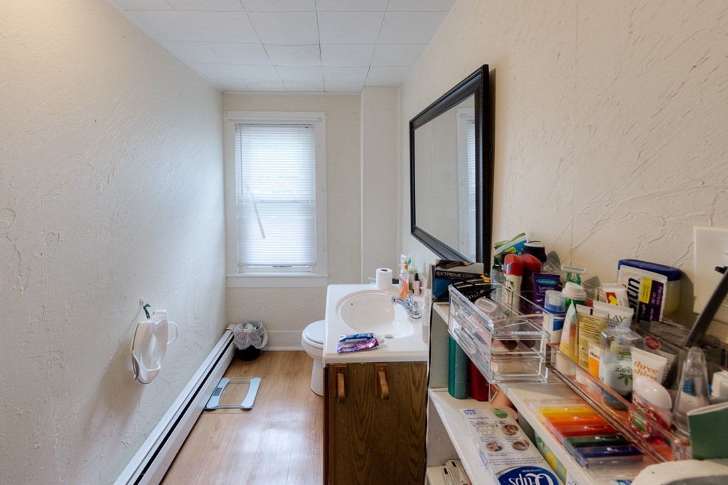 92 Mill Street Lancaster, MA 01523 - Photo 30 of 42 a bathroom with a sink mirror and a window
