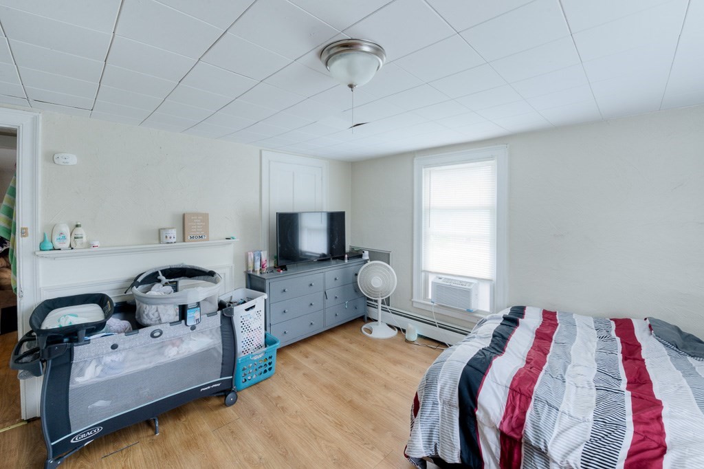 92 Mill Street Lancaster, MA 01523 - Photo 32 of 42 a bedroom with furniture or bed and a tv