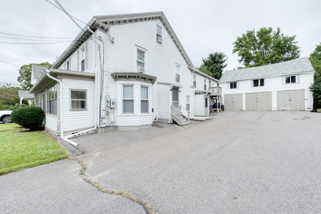 92 Mill Street Lancaster, MA 01523 - Photo 42 of 42 a view of a white house with a large space and a road