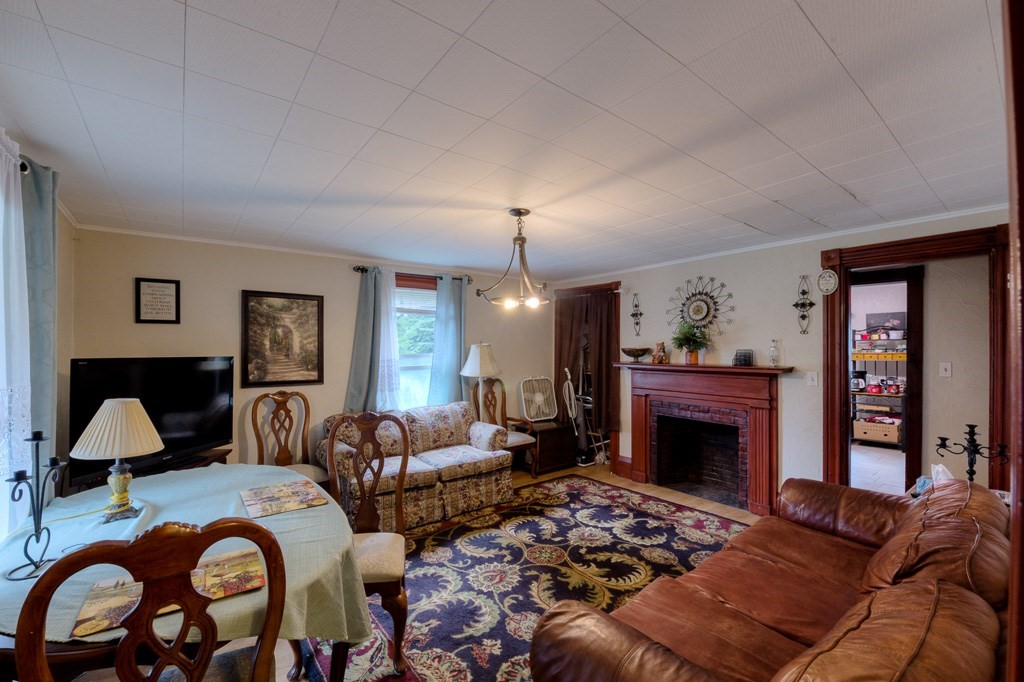 92 Mill Street Lancaster, MA 01523 - Photo 7 of 42 a living room with furniture a fireplace and a window