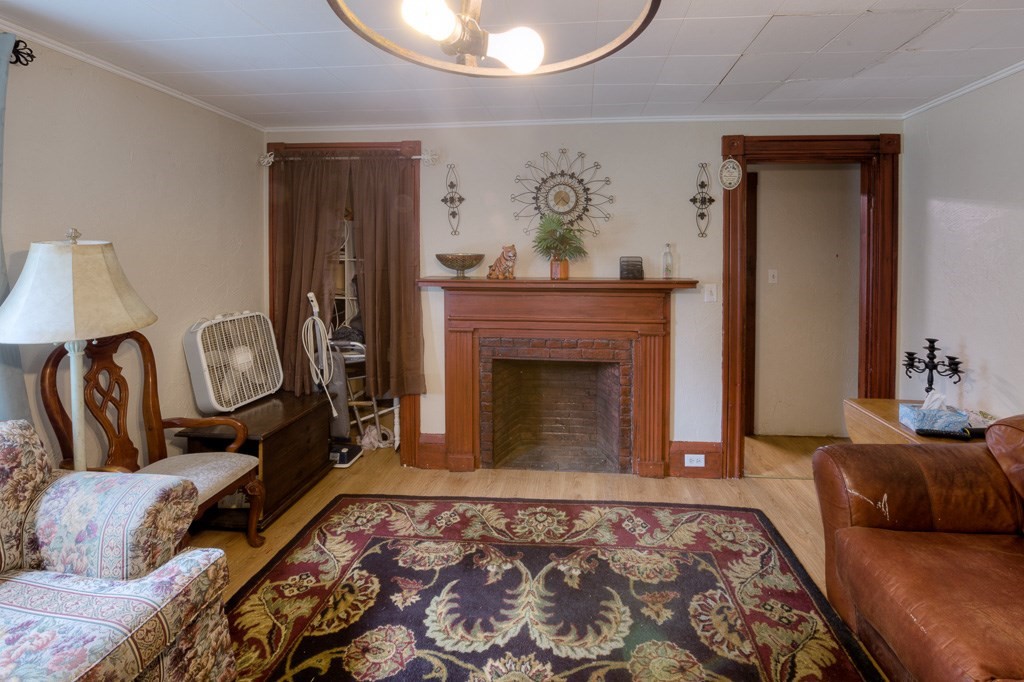 92 Mill Street Lancaster, MA 01523 - Photo 8 of 42 a living room with furniture and a fireplace