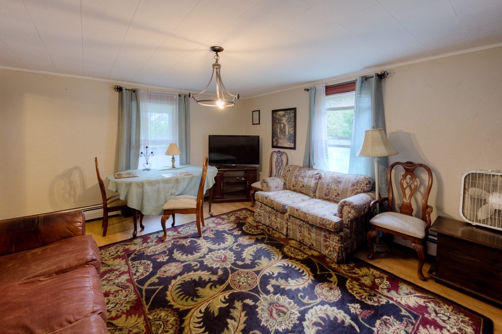 92 Mill Street Lancaster, MA 01523 - Photo 9 of 42 a living room with furniture and a fireplace