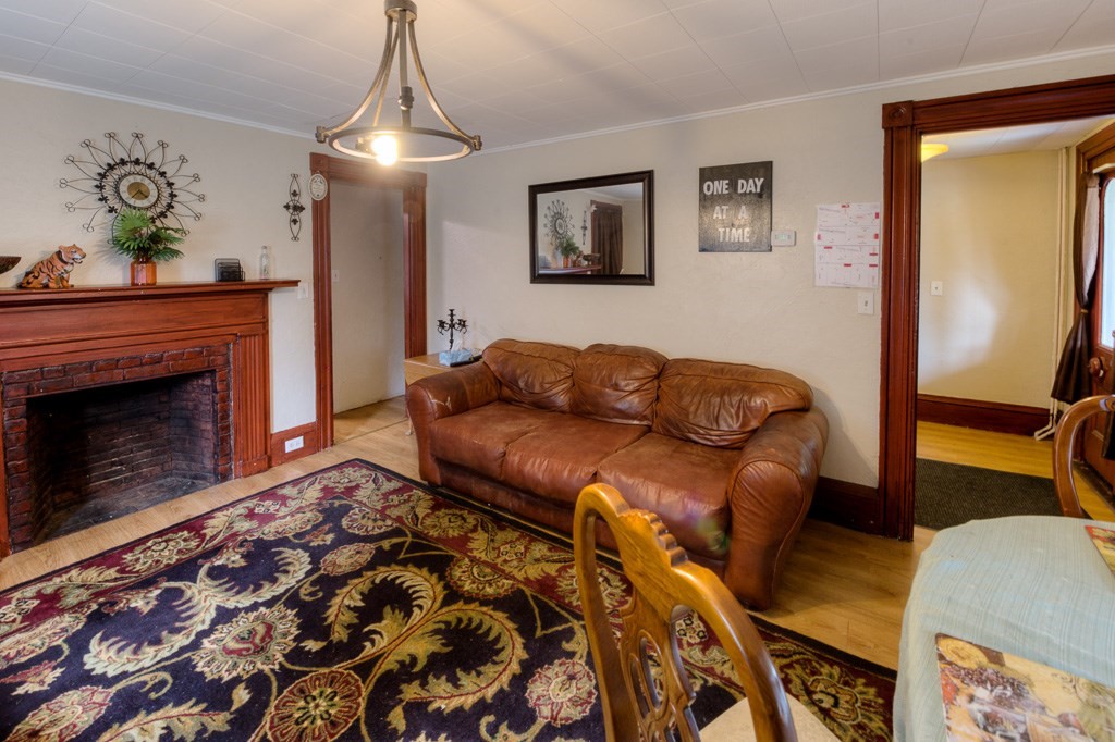 92 Mill Street Lancaster, MA 01523 - Photo 10 of 42 a living room with furniture and a fireplace