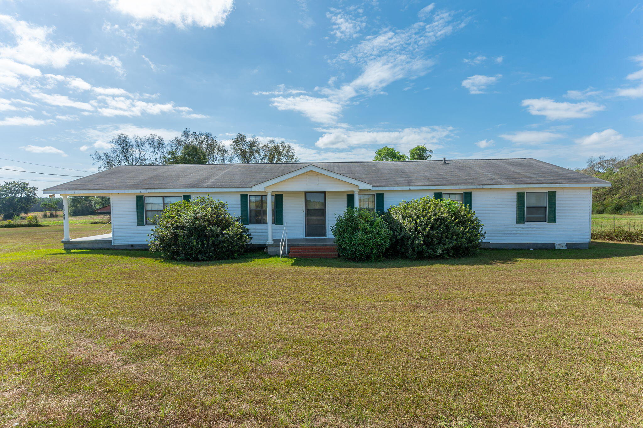 1950 Prescott Road Florala, AL 36442 - Photo 1 of 56 a front view of a house with a yard