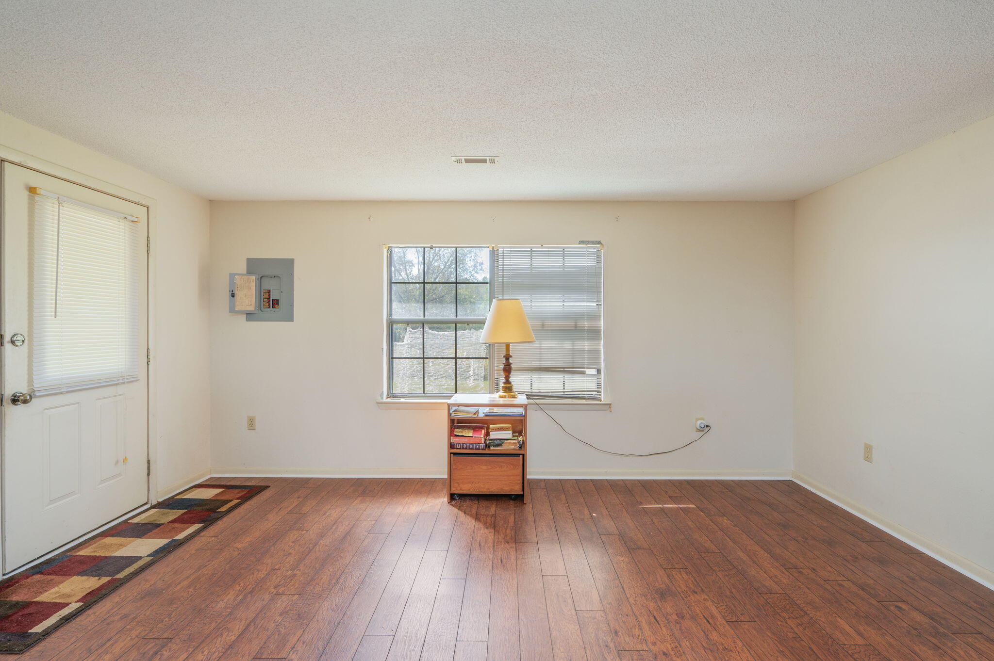 1950 Prescott Road Florala, AL 36442 - Photo 16 of 56 an empty room with wooden floor and window