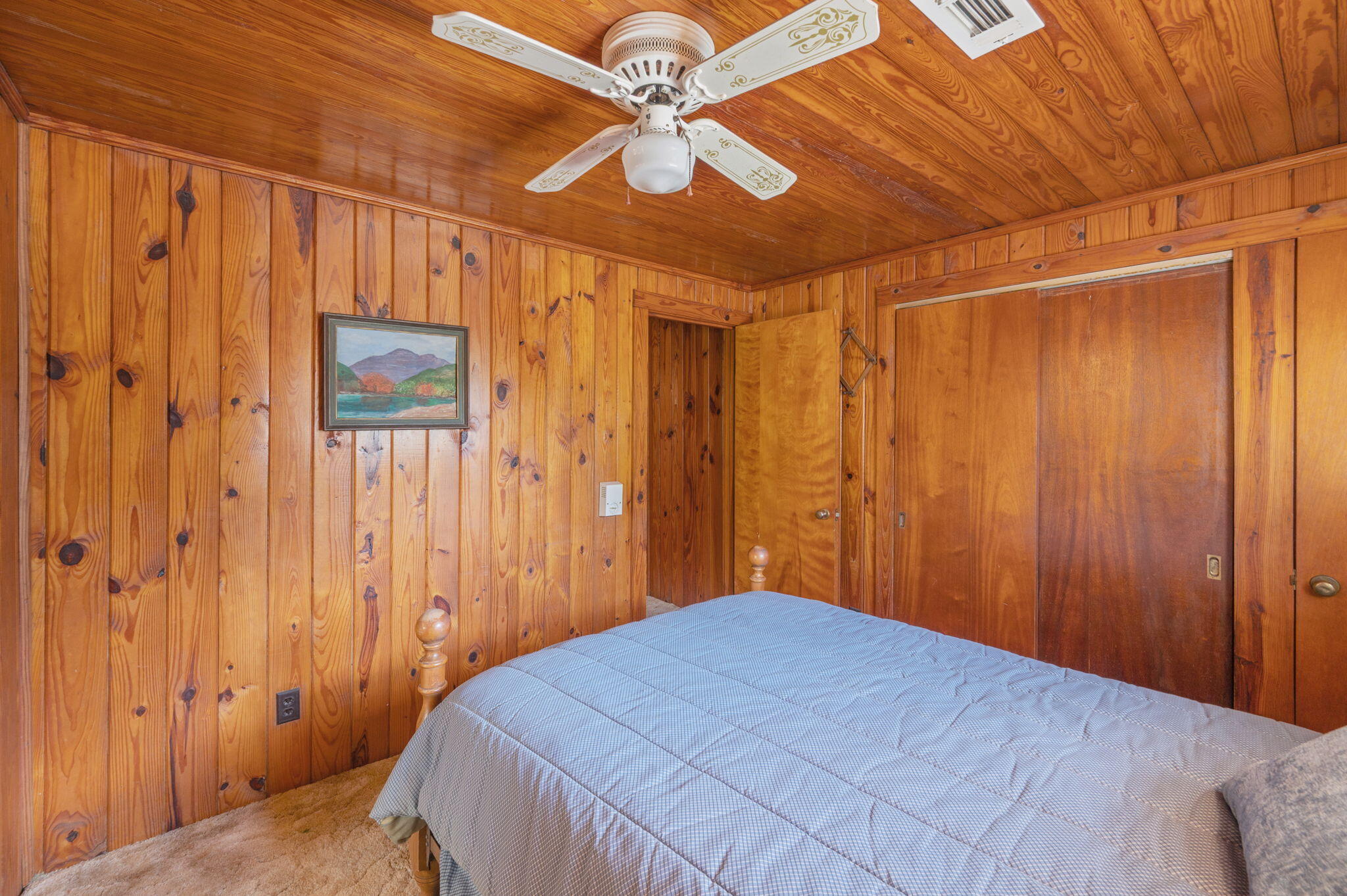 1950 Prescott Road Florala, AL 36442 - Photo 25 of 56 a bedroom with a bed and a chandelier