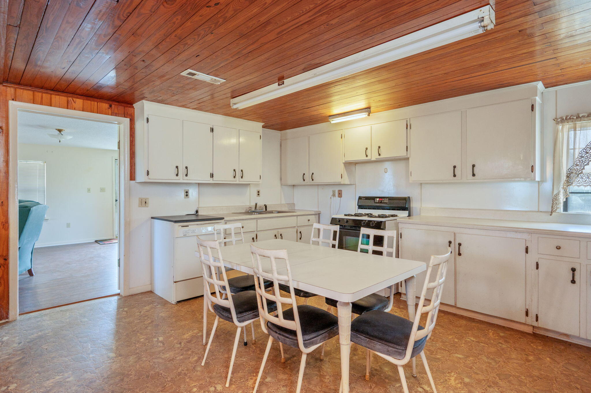 1950 Prescott Road Florala, AL 36442 - Photo 4 of 56 a kitchen with granite countertop a table chairs stove and cabinets