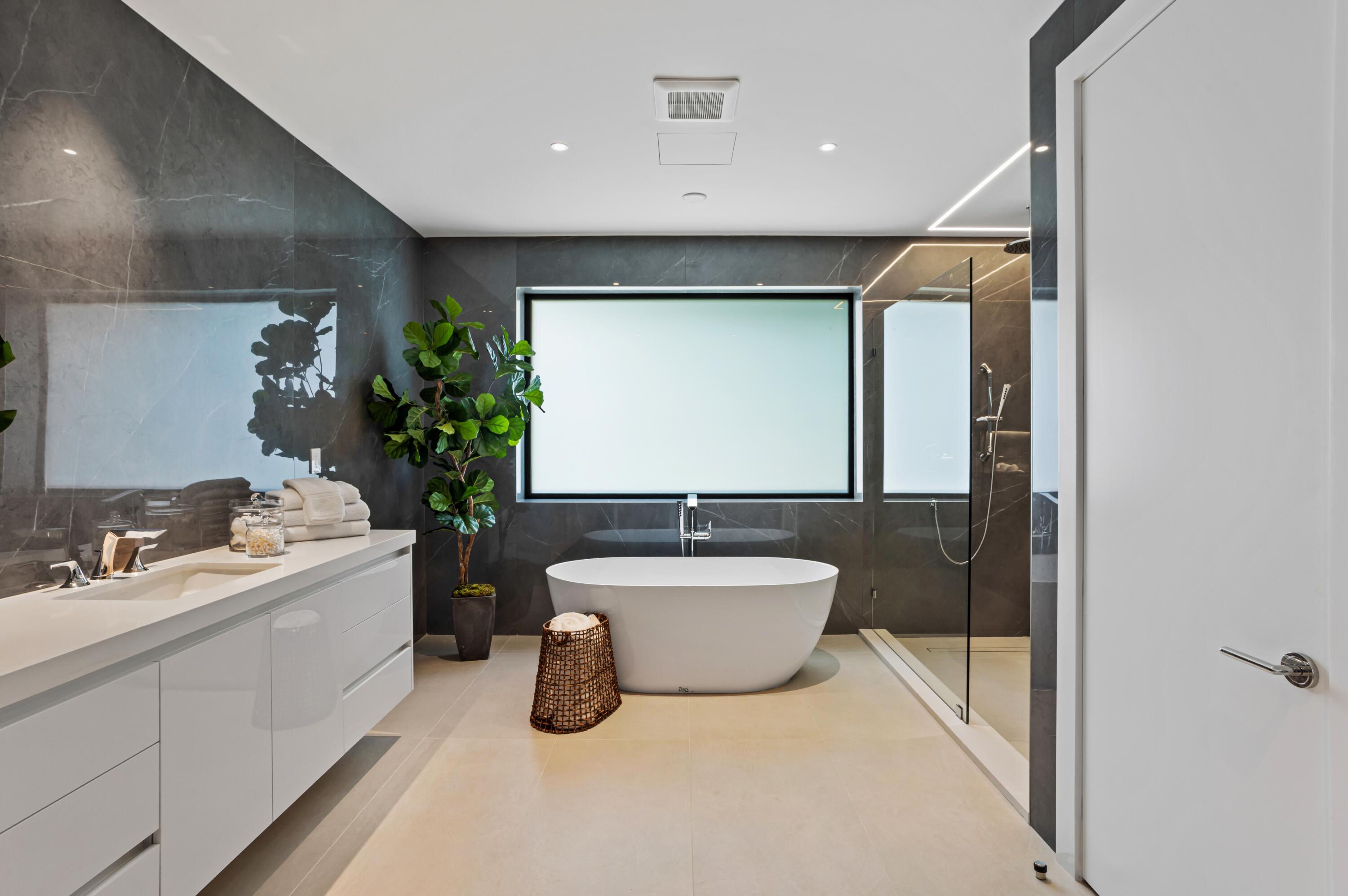 754 Oleander Street Boca Raton, FL 33486 - Photo 21 of 41 a bathroom with a granite countertop sink a toilet a mirror and bathtub