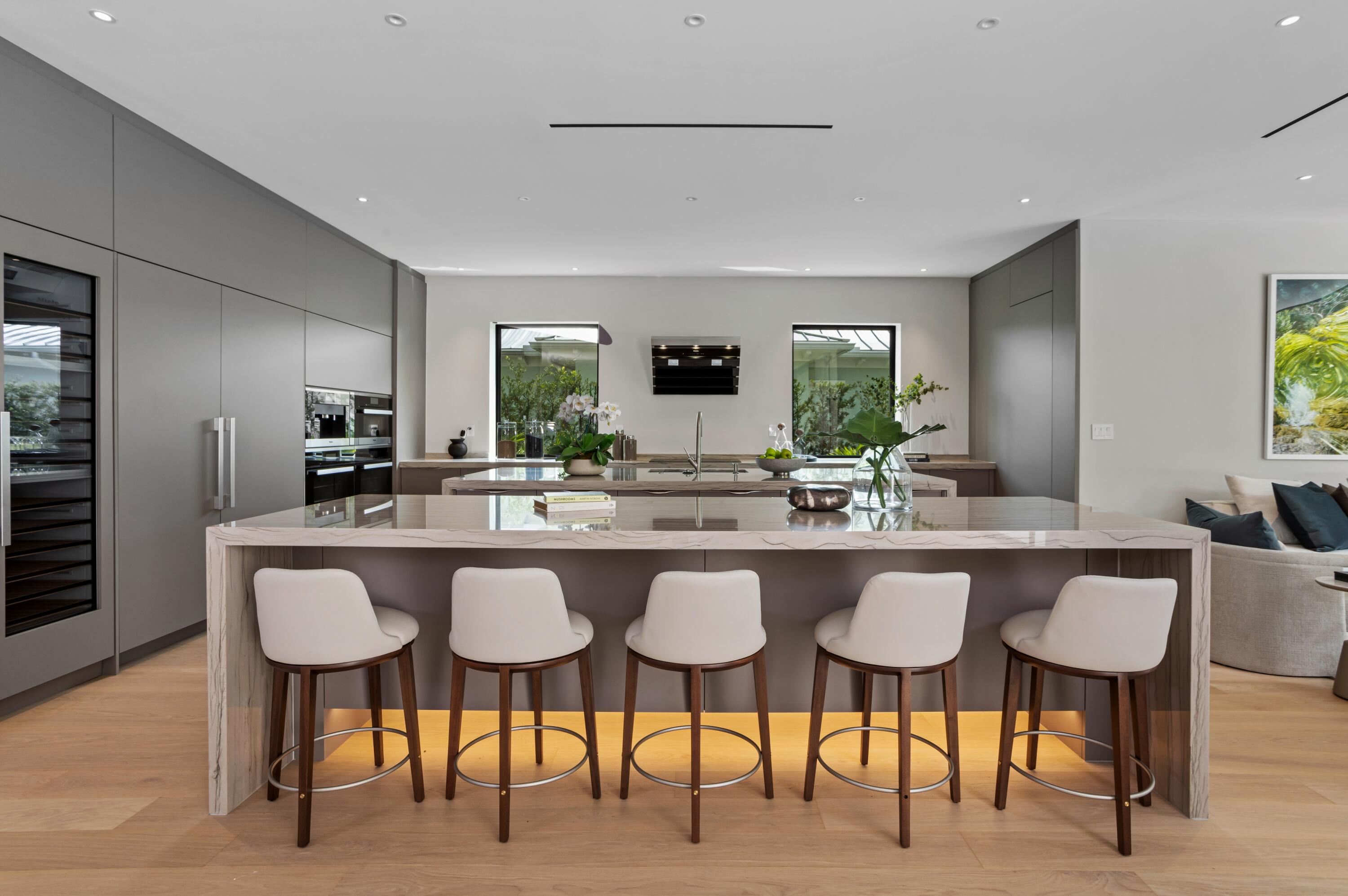 754 Oleander Street Boca Raton, FL 33486 - Photo 10 of 41 a kitchen with a dining table chairs and large counter top space