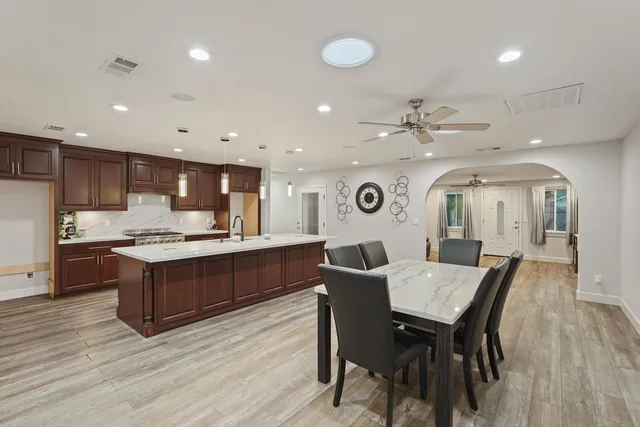 a large kitchen with a table and chairs in it