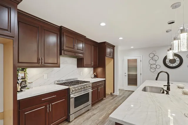 a kitchen with a sink and a stove top oven