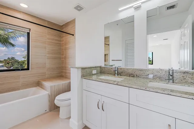 a bathroom with a toilet a sink and bathtub