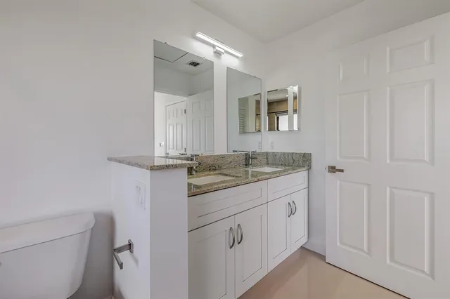a view of a bathroom from a hallway
