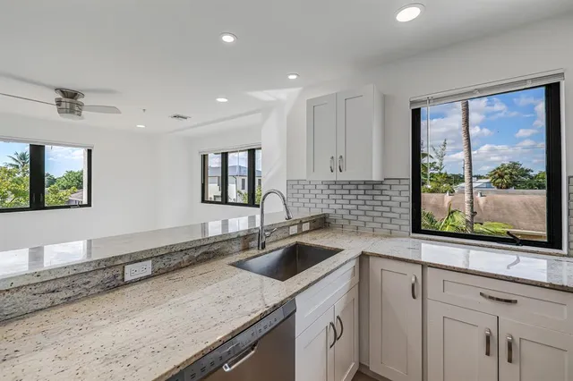 a kitchen with stainless steel appliances granite countertop a refrigerator and a stove top oven