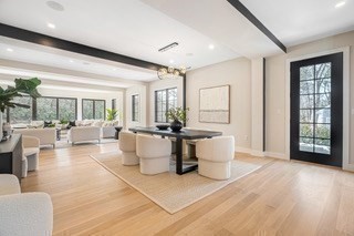 741 Boston Post Road Weston, MA 02493 - Photo 15 of 28 a living room with couches a coffee table and a large window with garden view