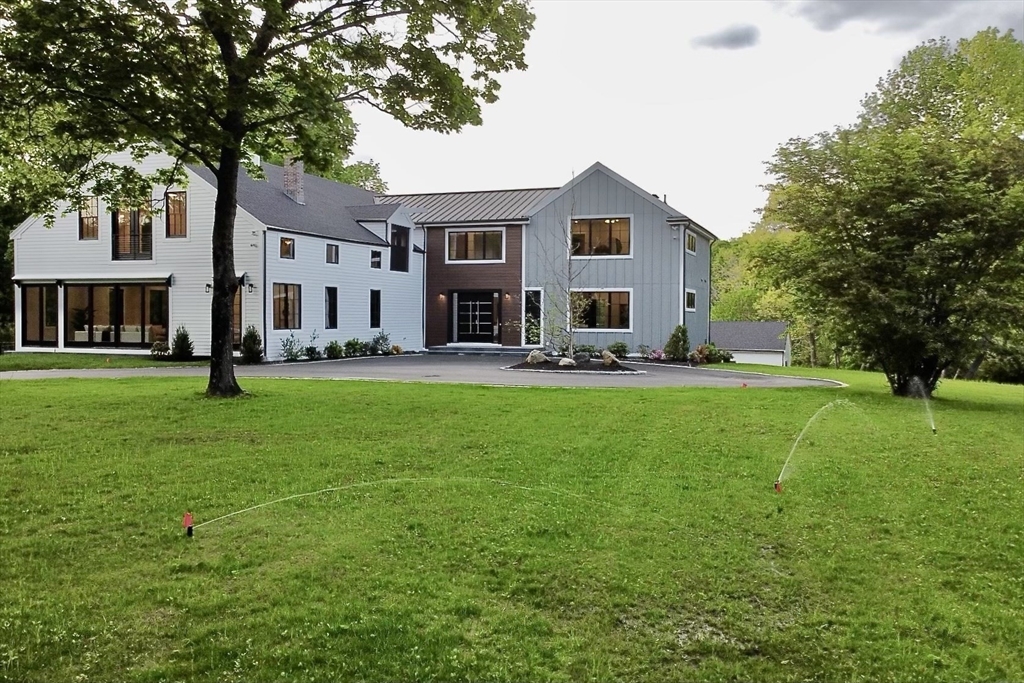 741 Boston Post Road Weston, MA 02493 - Photo 26 of 28 a front view of a house with garden and trees