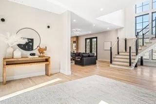 a living room with fireplace furniture and a wooden floor