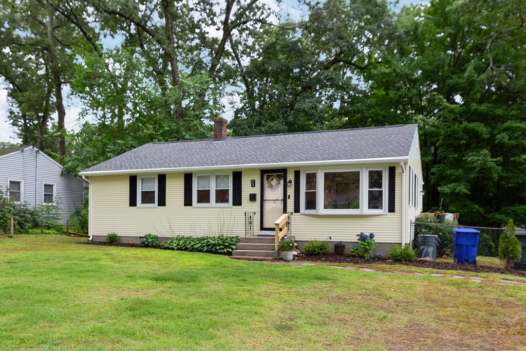 a front view of a house with a garden