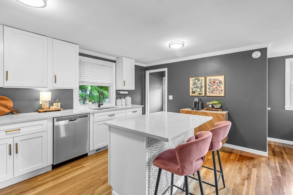 71 Endecott Street Springfield, MA 01118 - Photo 11 of 42 a kitchen with stainless steel appliances granite countertop a white cabinets and wooden floor