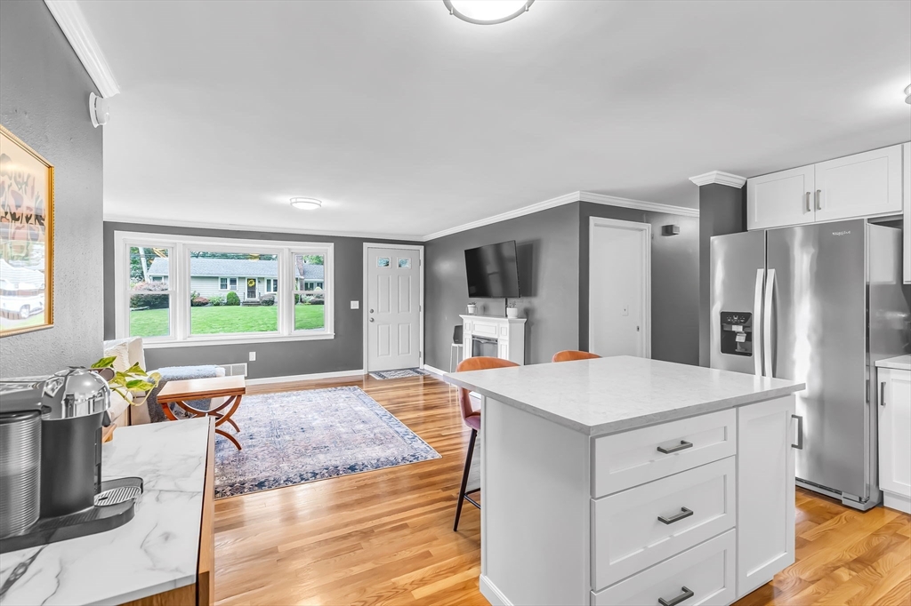 71 Endecott Street Springfield, MA 01118 - Photo 13 of 42 a large kitchen with kitchen island a large counter space a sink appliances and a large window