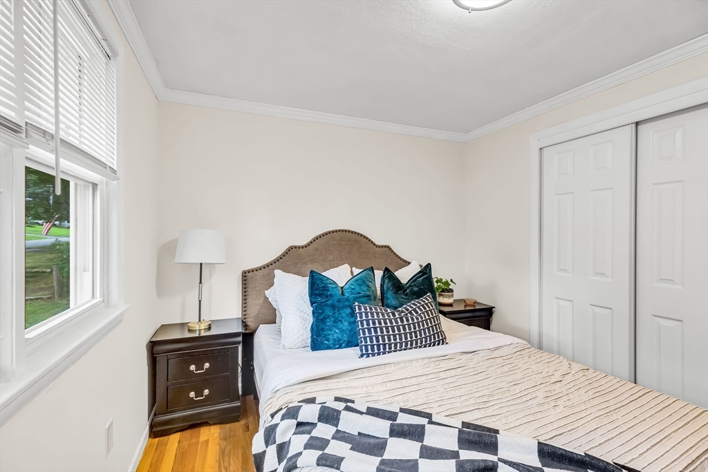 71 Endecott Street Springfield, MA 01118 - Photo 19 of 42 a bedroom with a bed and a tv on the dresser