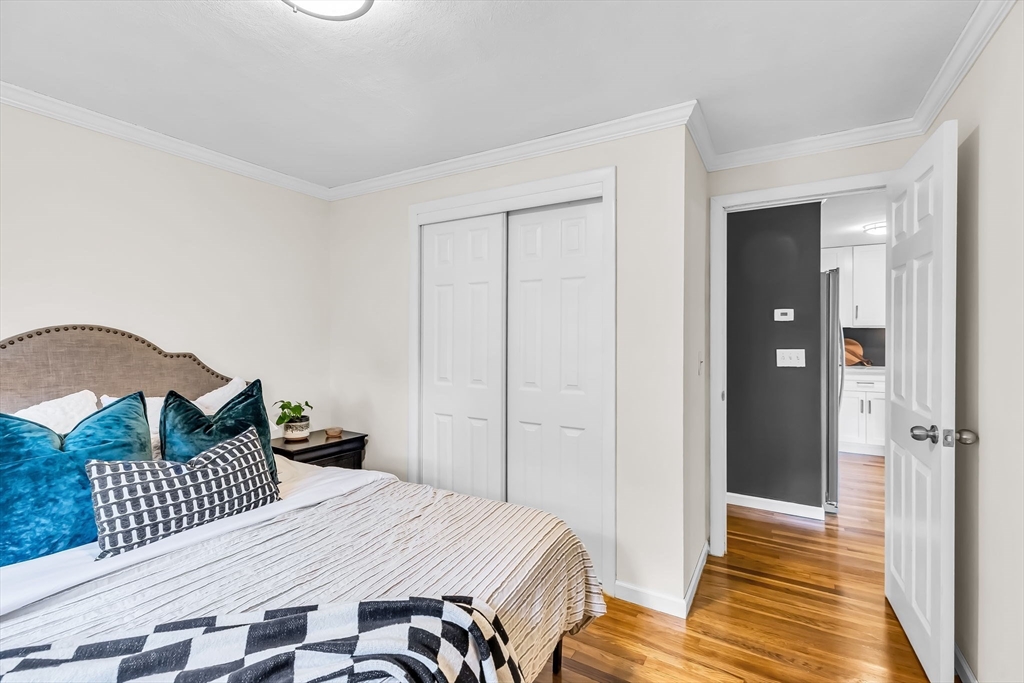 71 Endecott Street Springfield, MA 01118 - Photo 20 of 42 a bedroom with a bed and wooden floor