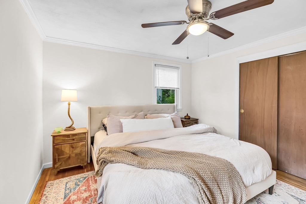 71 Endecott Street Springfield, MA 01118 - Photo 22 of 42 a bedroom with a bed and a chandelier