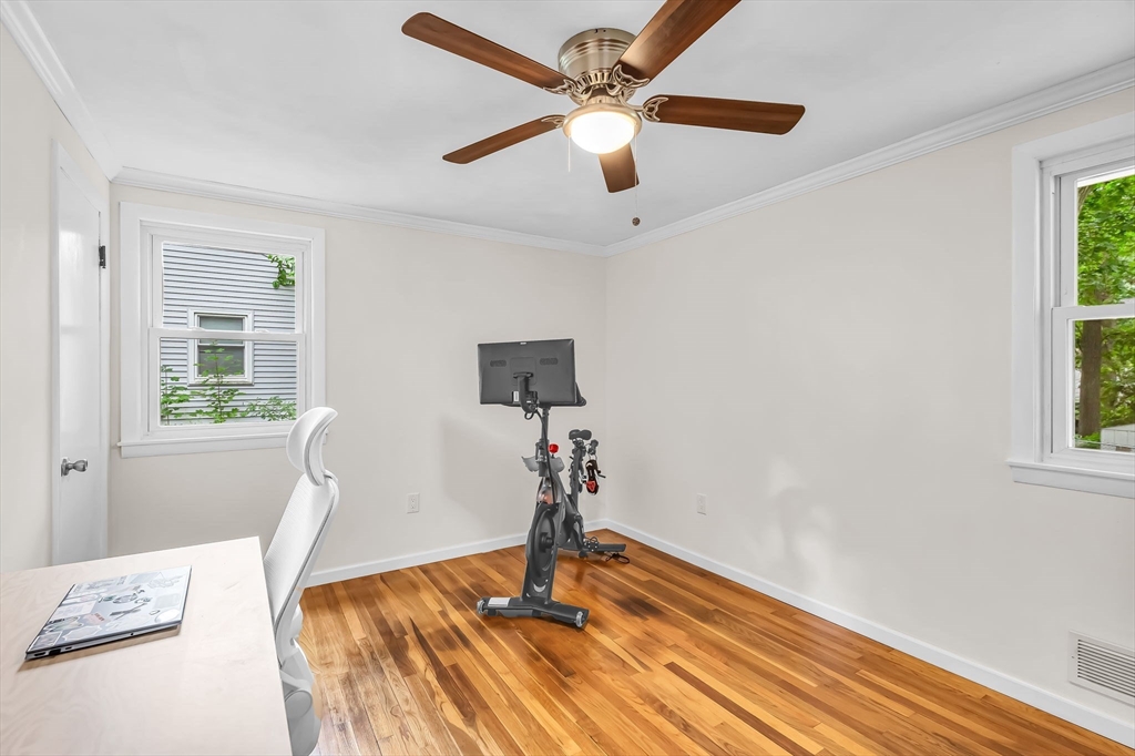 71 Endecott Street Springfield, MA 01118 - Photo 25 of 42 a bedroom with a bed and a chandelier