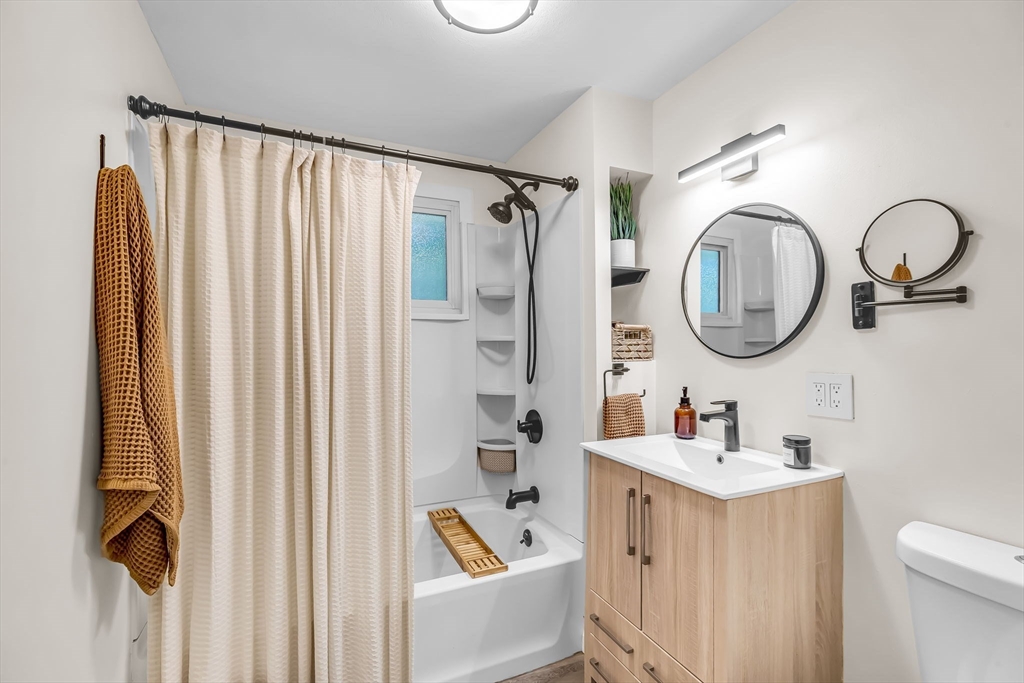 71 Endecott Street Springfield, MA 01118 - Photo 29 of 42 a bathroom with a sink a toilet and a mirror