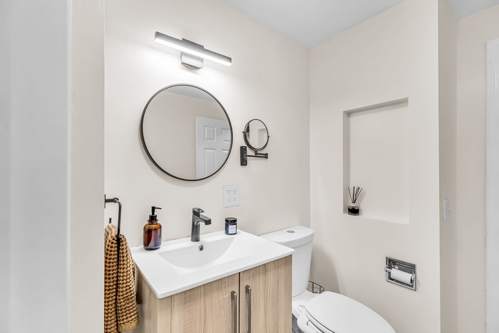 71 Endecott Street Springfield, MA 01118 - Photo 30 of 42 a bathroom with a sink a toilet and a mirror
