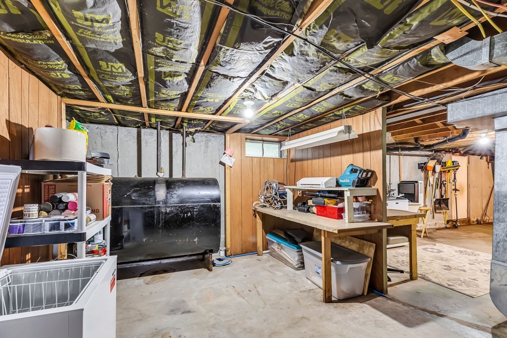 71 Endecott Street Springfield, MA 01118 - Photo 34 of 42 a storage room with stainless steel appliances kitchen island granite countertop lots of clutter