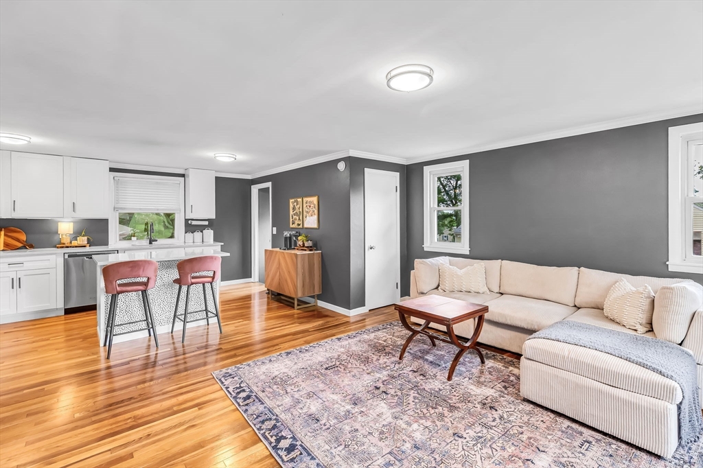 71 Endecott Street Springfield, MA 01118 - Photo 6 of 42 a living room with furniture and a dining table with wooden floor
