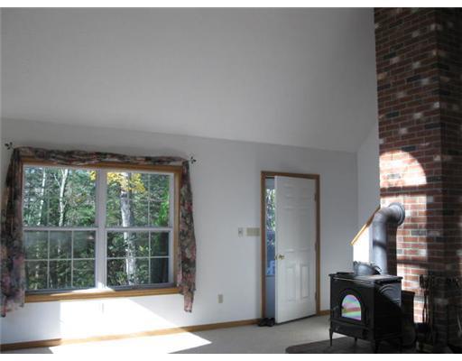 100 Abbott Road Lebanon, ME 04027 - Photo 7 of 11 Living Room. Brick wood stove hearth...