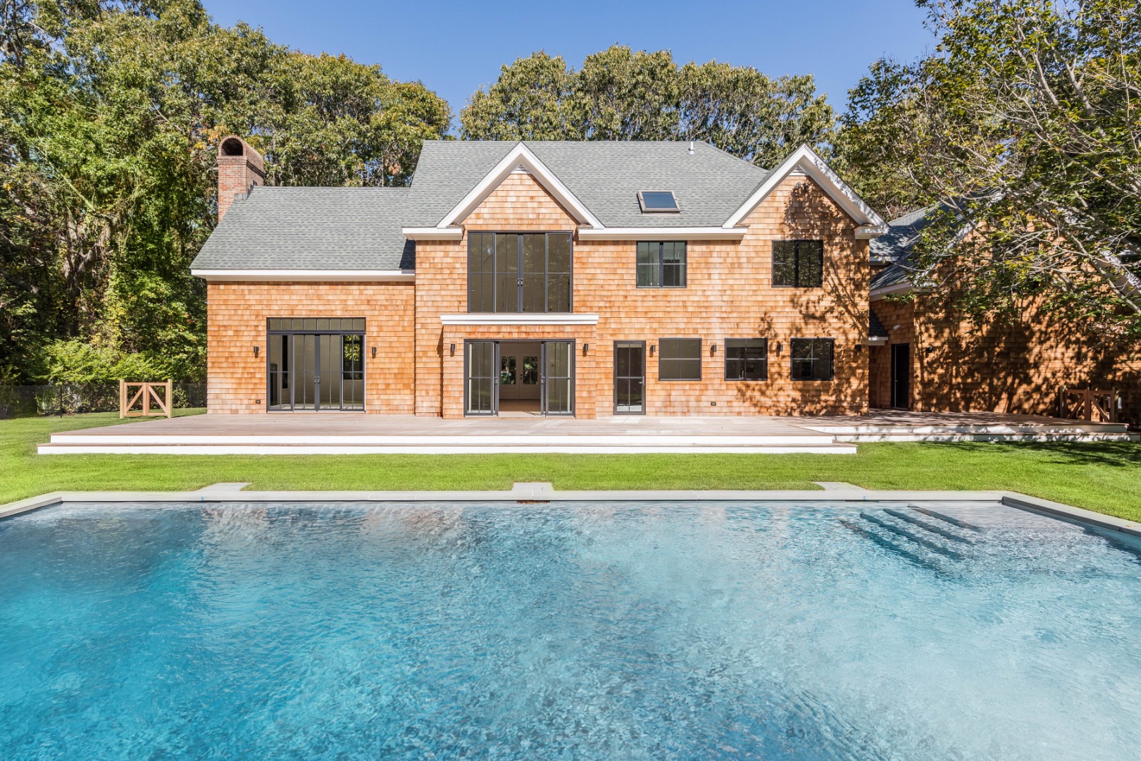 a view of a house with a swimming pool and a yard