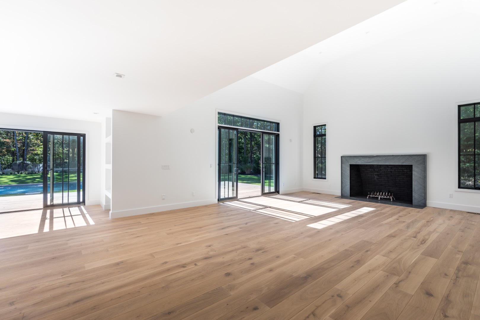 22 Oak Drive Sag Harbor, NY 11963 - Photo 14 of 35 a view of an empty room with wooden floor and a window