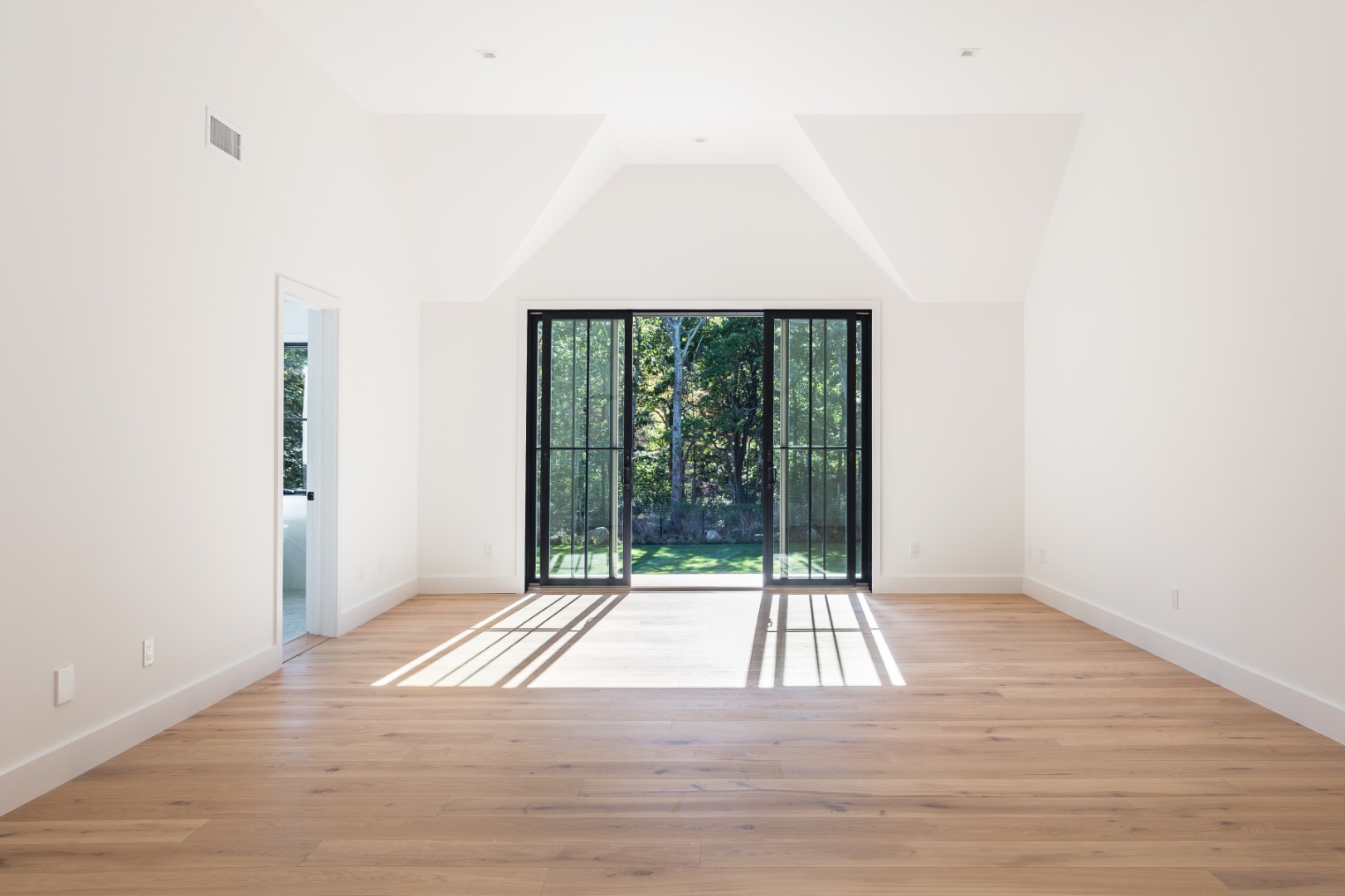 22 Oak Drive Sag Harbor, NY 11963 - Photo 19 of 35 a view of an empty room with wooden floor and a window