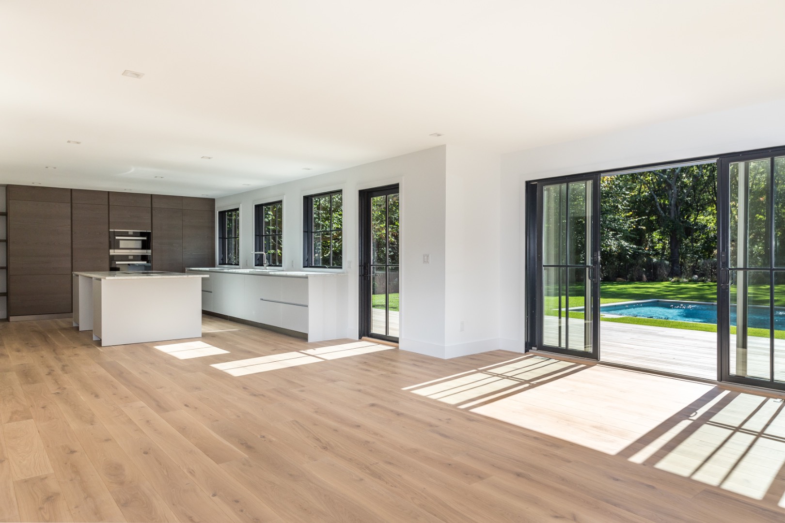 22 Oak Drive Sag Harbor, NY 11963 - Photo 8 of 35 a view of a kitchen with wooden floor and a fireplace
