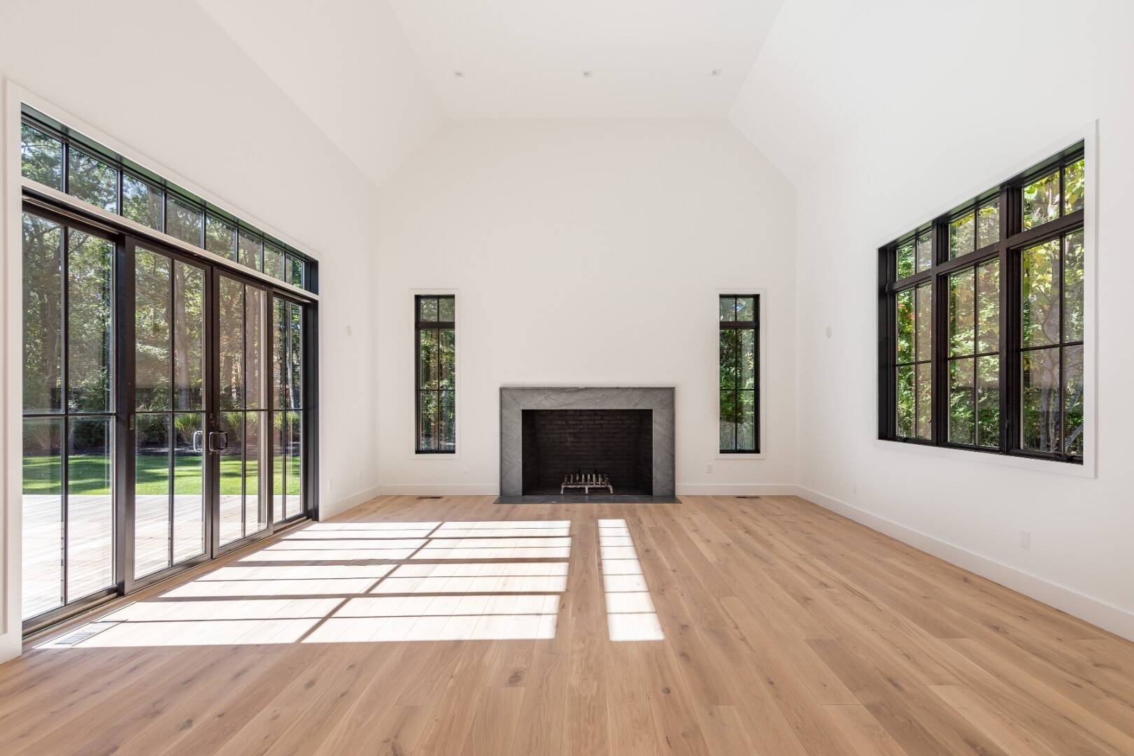 22 Oak Drive Sag Harbor, NY 11963 - Photo 10 of 35 a view of an empty room with wooden floor and a window