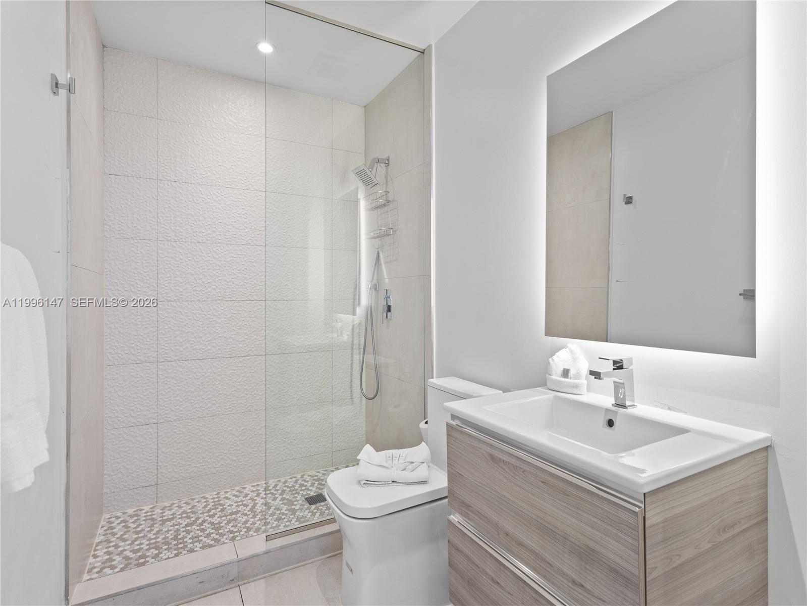 239 Southwest 9th Street, Unit 1403 Miami, FL 33130 - Photo 11 of 33 a bathroom with a sink toilet and shower