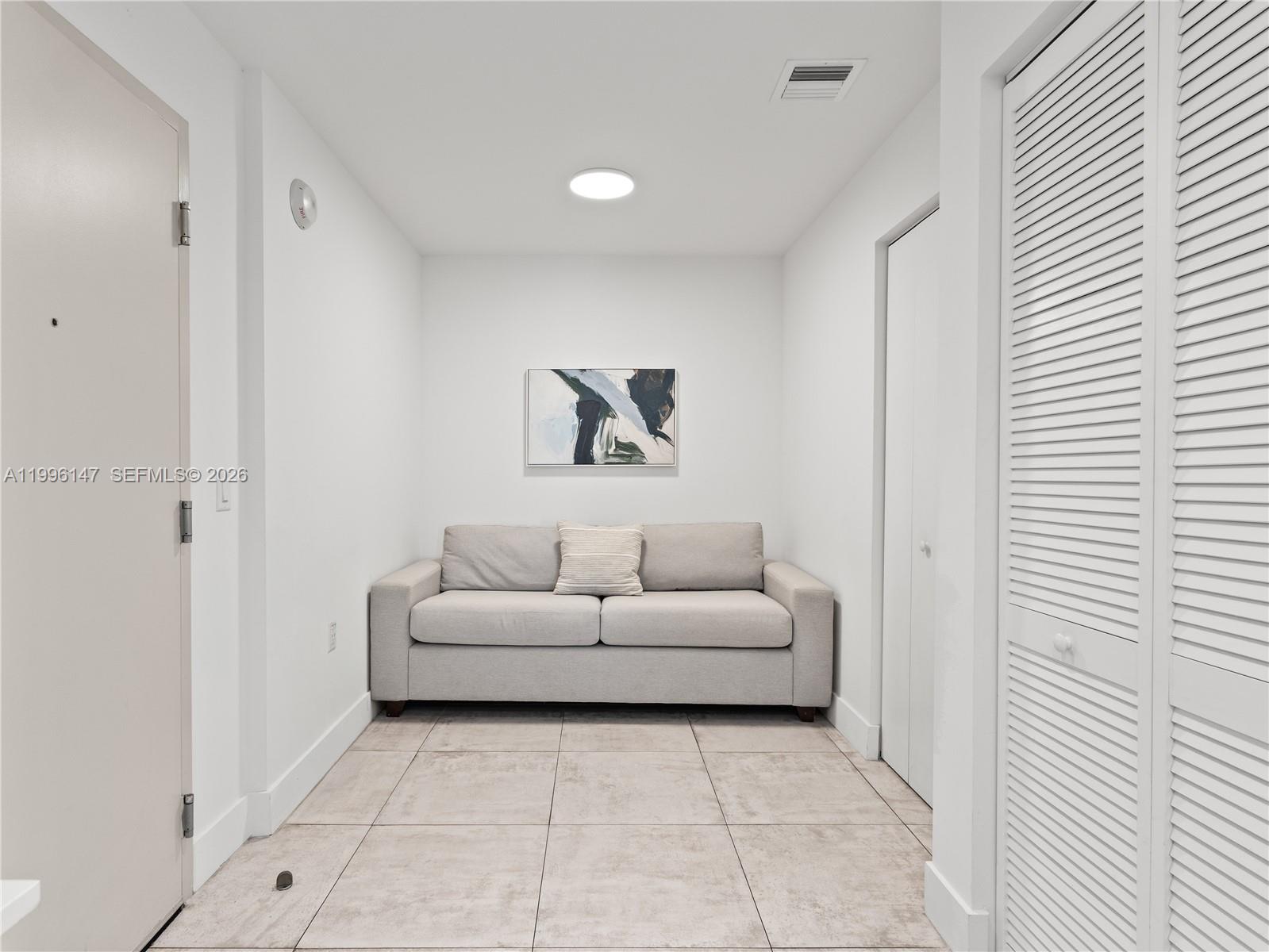 239 Southwest 9th Street, Unit 1403 Miami, FL 33130 - Photo 12 of 33 a living room with furniture and a white door