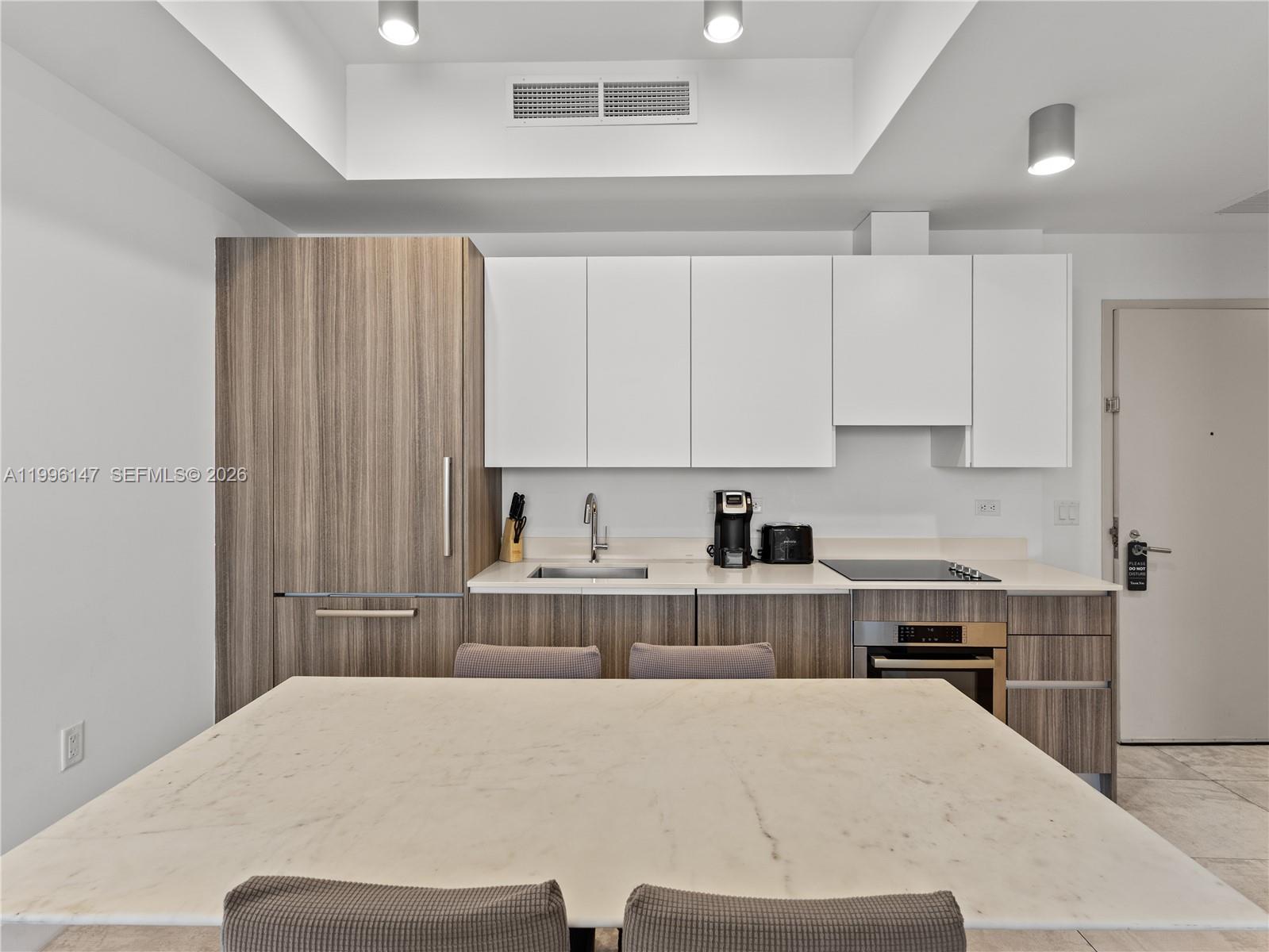 239 Southwest 9th Street, Unit 1403 Miami, FL 33130 - Photo 18 of 33 a bed room with a bed and white cabinets