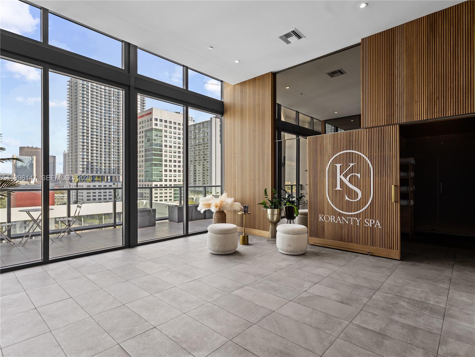 239 Southwest 9th Street, Unit 1403 Miami, FL 33130 - Photo 27 of 33 a view of living room kitchen with furniture and floor to ceiling window