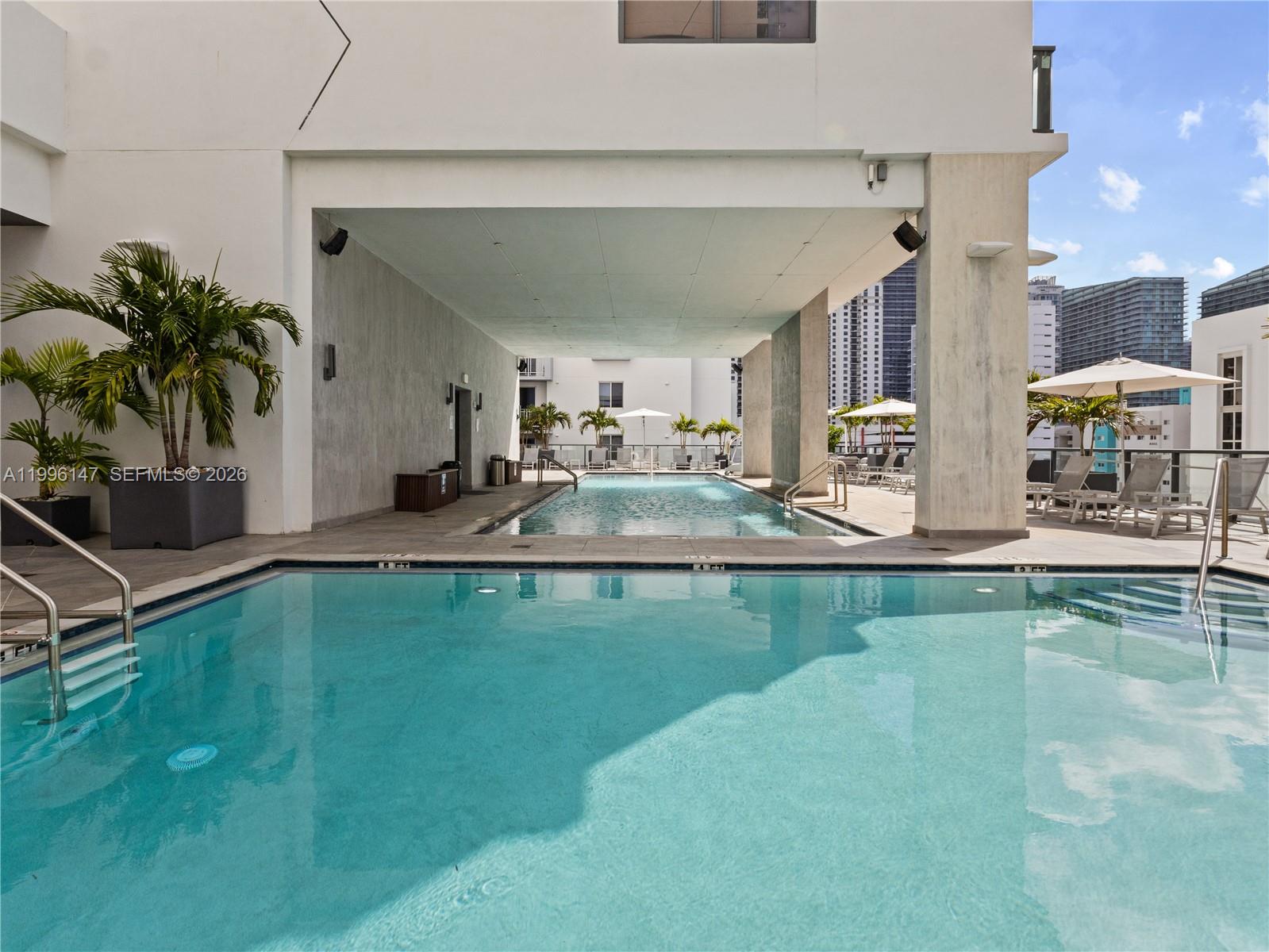 239 Southwest 9th Street, Unit 1403 Miami, FL 33130 - Photo 31 of 33 a swimming pool with outdoor seating and yard
