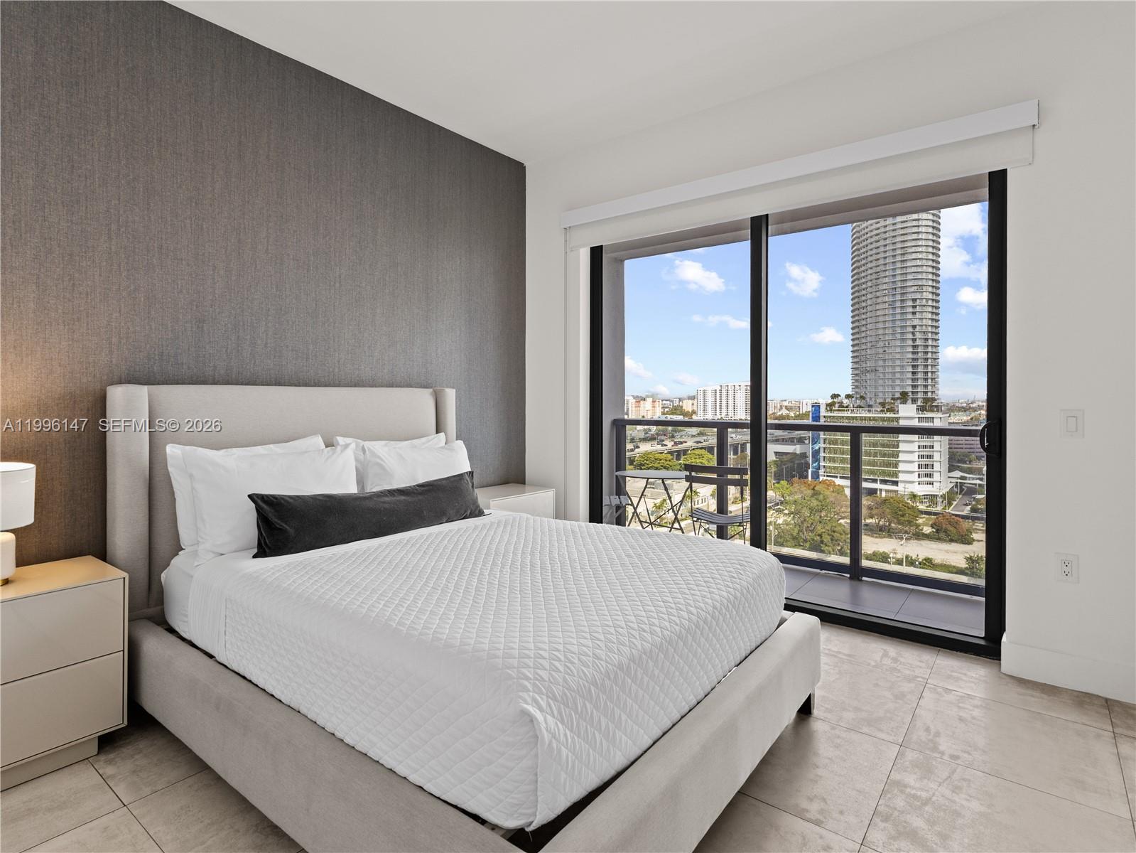 239 Southwest 9th Street, Unit 1403 Miami, FL 33130 - Photo 7 of 33 a bedroom with a large bed and a large window