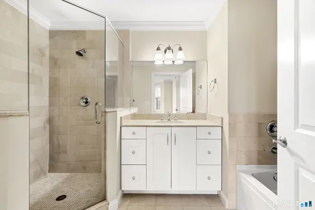 a bathroom with a double vanity sink mirror and shower