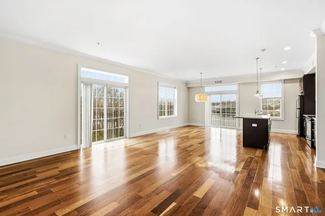a view of large kitchen with wooden floor and windows
