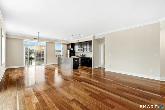 a view of kitchen and dining room with wooden floor