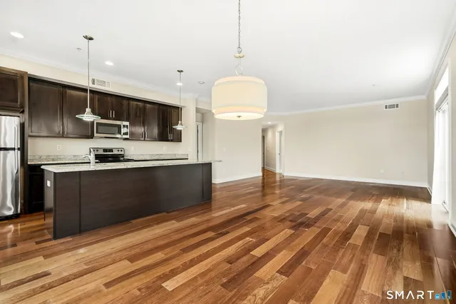 a kitchen with a sink stainless steel appliances and cabinets