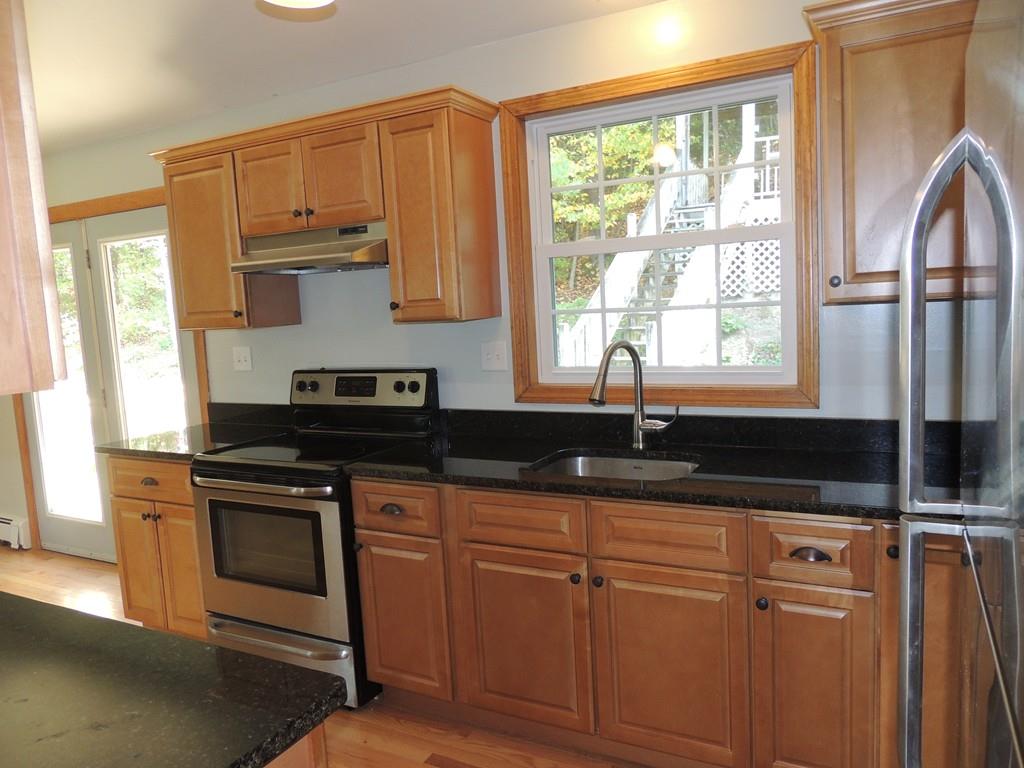 68 Cote Road Monson, MA 01057 - Photo 12 of 24 a kitchen with granite countertop a sink a stove and cabinets